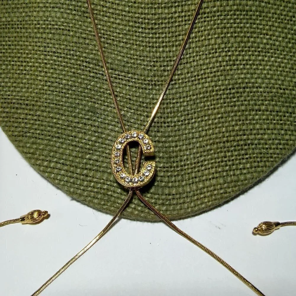 Women`s gold tone initial C lariat crystal neckl.